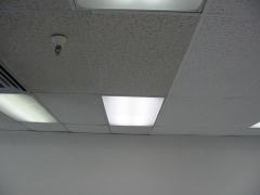 Acoustical ceiling tiles being cleaned