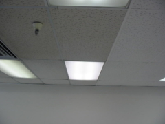 Acoustical ceiling tiles being cleaned